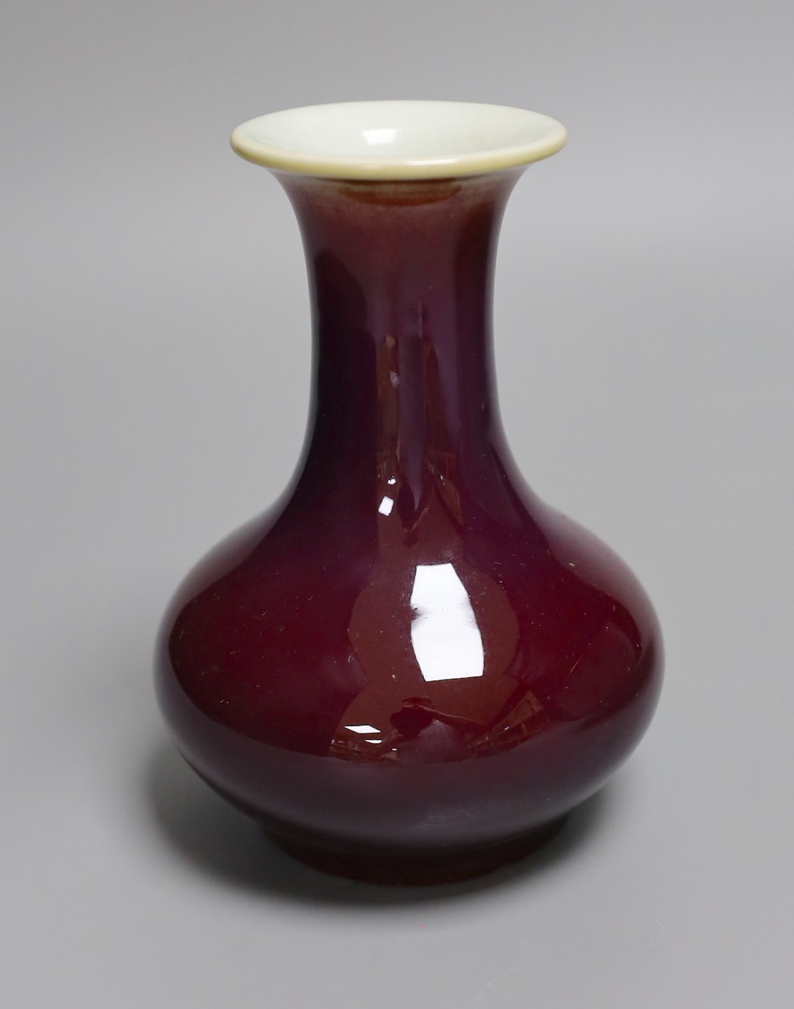 An 18th century Japanese Imari dish (af), another Imari dish, an 18th century Chinese export bowl (af) and a Chinese sang de boeuf vase, diameter of largest bowl 29cm